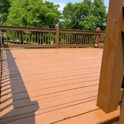 Stained wood deck and railing finished in a warm terracotta tone