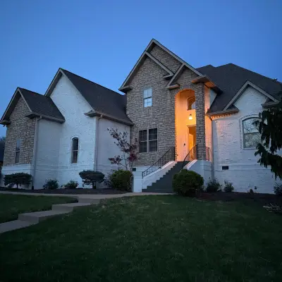 Stone-and-brick home at dusk, exterior painting by Mr. Wu's Painting
