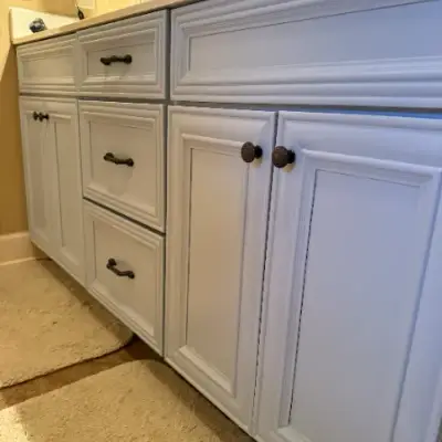 Bathroom vanity painted white with oil-rubbed bronze hardware