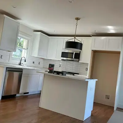 Kitchen with white shaker cabinets, subway tile backsplash, and stainless appliances
