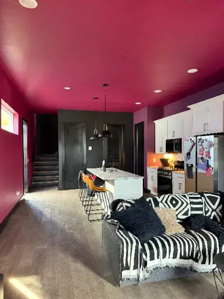 Open living space with a bold magenta ceiling by Mr. Wu's Painting