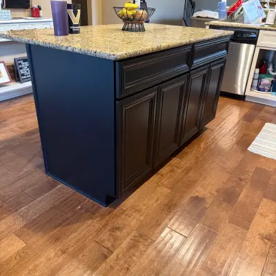 Kitchen island painted navy blue with black cabinet doors