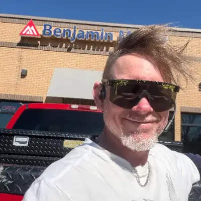 Painter smiling outside a Benjamin Moore paint store